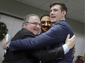 Brian Mason (left/Alberta Minister of Infrastructure and Minister of Transportation), Amarjeet Sohi (middle/Canada Minister of Infrastructure and Communities) and Don Iveson (right/Mayor of Edmonton) embrace after announcing in Edmonton on Dec. 16, 2016 the joint government funding of more than $1 billion for the conversion of a portion of Highway 16, also known as the Yellowhead Trail, from an expressway into a freeway without traffic signals.