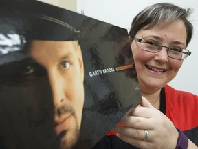 Garth Brooks fan Leanne Heuchert poses for a photo at her work in Edmonton on Friday, Feb. 10, 2017.