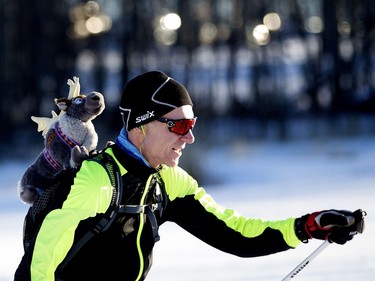 A cross-country skier with a stuffed toy on his back takes part in the Canadian Birkebeiner on Saturday, Feb. 11, 2017.