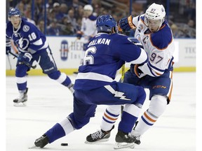 Tampa Bay Lightning defenseman Anton Stralman (6), of Sweden, stops Edmonton Oilers center Connor McDavid (97) during the first period of an NHL hockey game Tuesday, Feb. 21, 2017, in Tampa, Fla.