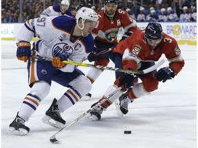 Edmonton Oilers center Connor McDavid (97) and Florida Panthers defenseman Keith Yandle (3) go for the puck during the first period of an NHL hockey game, Wednesday, Feb. 22, 2017, in Sunrise, Fla.