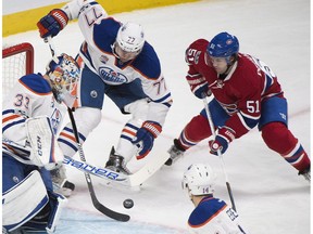 Montreal Canadiens' David Desharnais (51) moves in on Edmonton Oilers goaltender Cam Talbot as Edmonton's Oscar Klefbom (77), Jordan Eberle (14) and Adam Larsson (6) defend in Montreal on Feb. 5, 2017. (The Canadian Press)