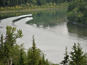 A jet ski and a jet boat make waves in the calm waters of the North Saskatchewan river heading west from the Dawson Bridge towards downtown in this August 2009 file photo.