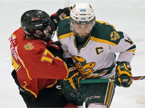 University of Alberta Golden Bears Kruise Reddick (right) collides with Calgary Dinos Cain Franson during the Canada West final at Clare Drake Arena on March 5, 2015. This weekend will see their first playoff action since. (