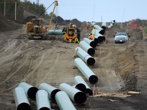 Construction workers assemble the new Enbridge pipeline to Hardisty southeast of New Sarepta on Monday Sept. 29, 2014. File photo.