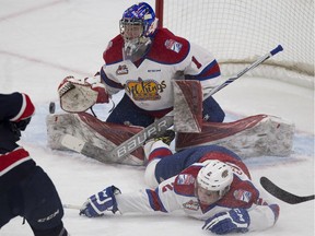 Edmonton Oil Kings goalie Patrick Dea makes a save against the Regina Pats as teammate Riley Stadel slides into him during WHL action against the Regina Pats on Feb. 10, 2017, at Edmonton's Rogers Place.