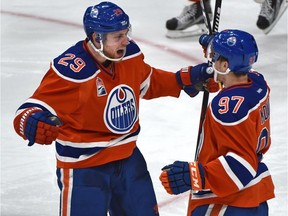Edmonton Oilers forwards Leon Draisaitl, left, and Connor McDavid celebrate Draisaitl's goal on Dec. 17, 2016, against the Tampa Bay Lightning  at Rogers Place in Edmonton.