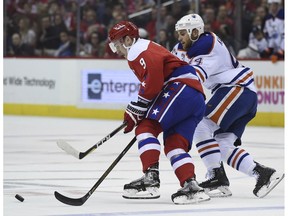 Edmonton Oilers right wing Zack Kassian (44) chases down Washington Capitals defenseman Dmitry Orlov (9), of Russia, for the puck during first period of an NHL hockey game, Friday, Feb. 24, 2017, in Washington.