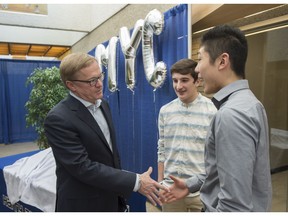 Education Minister David Eggen, left, speaks with speaks with Jacob Dunn and  Andrew Li at Harry Ainlay High School when he announced a new provincial student engagement initiative called the Minister's Youth Council on Feb. 27, 2017.