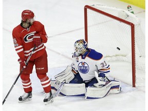Carolina Hurricanes' Elias Lindholm (16), of Sweden, watches the game-winning goal scored by Hurricanes' Sebastian Aho (20), not shown, go past Edmonton Oilers goalie Cam Talbot (33) during the third period of an NHL hockey game in Raleigh, N.C., Friday, Feb. 3, 2017. Carolina won 2-1.