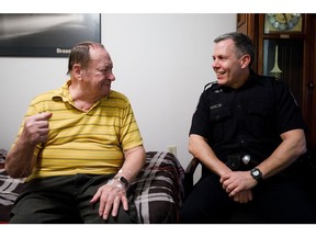 Ernie Saruk, 78, left, shares a story with Cst. Brian Meyer at his home in Edmonton, Alta., on Saturday, Feb. 18, 2017. The 51-year-old police officer, who drove trucks for a living before law enforcement, went above and beyond the call of duty when he went to check on Saruk, and visited him in the hospital. (Codie McLachlan/Postmedia)