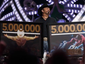 Garth Brooks celebrates the 5 millionth Garth Brooks ticket sold during his 2017 tour on stage at Rogers Place in Edmonton on Friday, February 24, 2017. A Garth Brooks banner was revealed in the rafters during the concert.