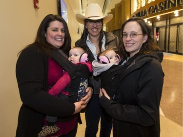 Garth Brooks fan Liz Ogston and daughter Zola ,10 months, (l) Sherri Cummins,(c) and Melissa Dussault and daughter Aubree 6 months (r) head into the first of 9 shows on Friday February 17, 2017 in Edmonton.  Greg  Southam / Postmedia  (To go with a Catherine Griwkowsky story.)