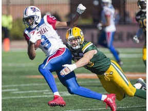 Montreal Alouettes receiver Kenny Stafford, left, is tackled by Edmonton Eskimos safety Neil King during first half CFL football action in Montreal, Monday, October 10, 2016.