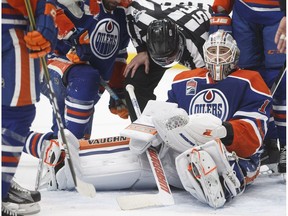 Edmonton Oilers goalie Laurent Brossoit sits in his crease after a pile up around the net against the Minnesota Wild in Edmonton on Jan. 31, 2017. (The Canadian Press)