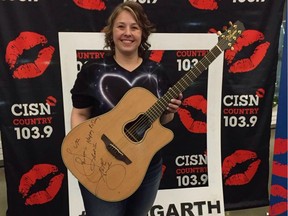 Lisa Chouinard with Garth Brooks' signed guitar. Brooks gave Chouinard his guitar at his concert in Edmonton on February 23, 2017 after hearing it was her birthday.