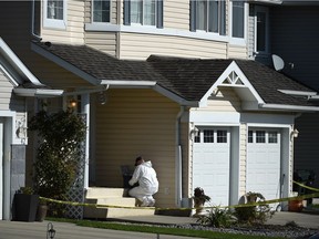 An RCMP forensics officer investigates at the Sherwood Park home of Melanie Hunter on Sept. 23, 2015. Hunter was found deceased inside, and her estranged husband, Brian Beglau, 60, pleaded guilty to second-degree murder in connection to the death.