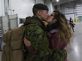 Master Cpl. Dennis Martens gives his wife Amanda a kiss after returning on Friday February 24, 2017 from a  six month deployment on Operation Reassurance in Poland.