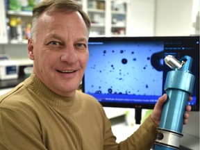 Intelirain owner Cam Cote holds a sprinkler head he and a colleague developed. The system uses a little weather station to measure wind speed and direction to counter the elements and spray water only where it's needed.