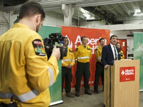 Agriculture and Forestry Minister Oneil Carlier, right, announces Alberta's plan for the upcoming  wildfire season at the Alberta Wildfire Provincial Warehouse and Service Centre in Edmonton on Wednesday, Feb. 15, 2017.