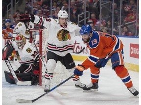 Patrick Maroon (19) of the Edmonton Oilers, attempts a to get the puck in front of goalie Scott Darling of the Chicago Blackhawks at Rogers Place in Edmonton on Feb. 11, 2017.