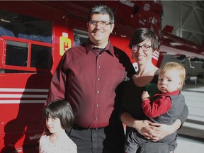 RCMP Cpl. Marcus Hirschfield, left, with his wife, Holly Hirschfield and two of their children, Logan, 1, right, and Sophia, 5, left, inside the STARS Air Ambulance Edmonton hangar at 1519 35 Ave. East, on Feb. 14, 2017. Four years ago, Marcus Hirschfield's RCMP cruiser was hit by a truck, breaking both of his legs and trapping him inside. Hirschfield was rescued by STARS.