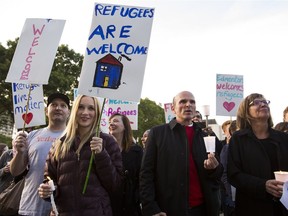 Supporters hold up welcome signs and cheer during a Refugees Welcome rally held at the Alberta Legislature in Edmonton, Alta., on Tuesday Sept. 8, 2015. Hundreds of people joined a rally and candlelight vigil for Syrian refugees while calling for Canada to open its doors to people fleeing the civil war in Syria.