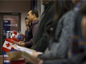 New Canadians sing Oh Canada during a citizenship ceremony held at Rexall Place on Friday, Oct. 17, 2014. A new Statistics Canada report predicts the proportion of Alberta's population made up of immigrants could rise to 31 per cent within 20 years.