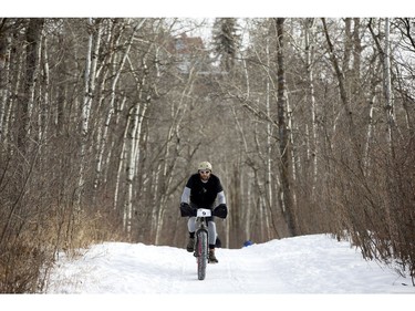 A cyclists makes their way down a Hawrelak Park trail during the FatBike Fest race at the Silver Skate Festival, in Edmonton Sunday Feb. 12, 2017. Photo by David Bloom