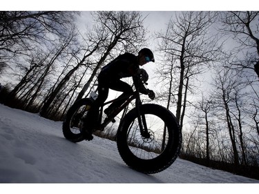 A cyclists makes their way down a Hawrelak Park trail during the FatBike Fest race at the Silver Skate Festival, in Edmonton Sunday Feb. 12, 2017. Photo by David Bloom