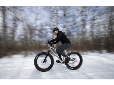 A cyclists makes their way down a Hawrelak Park trail during the FatBike Fest race at the Silver Skate Festival, in Edmonton Sunday Feb. 12, 2017. Photo by David Bloom