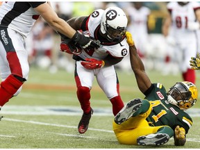 Edmonton Eskimos defensive end Odell Willis takes down Ottawa RedBlacks running back Travon Van at Commonwealth Stadium in Edmonton on June 25, 2016. (Ian Kucerak)