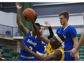 University of Alberta Golden Bears' Mamadou Gueye dives for the ball against the University of Lethbridge Pronghorns during the first game in the best of three Canada West quarter-final series on Thursday, Feb. 23, 2017, at the Saville Community Sports Centre. (Greg Southam)