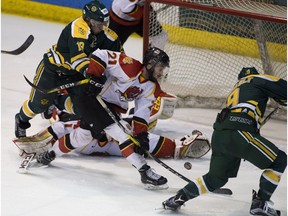 University of Alberta Golden Bears' Stephane Legault scores the game winning goal against the University of Calgary Dinos Matt Greenfield during the Canada West semifinal on Feb. 25, 2017 at Clare Drake Arena in Edmonton. The Bears went on to capture the conference championship in Saskatoon on the weekend. (Greg Southam)