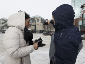 University of Alberta researcher Rob Shields (right) and intern Nathalia Osorio are using smartphone applications to crowd-source a study on walking and traffic signal patterns in Edmonton. It's an attempt to bring the human experience back into traffic analytics.