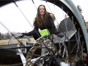 Natasha Pye, second-year University of Alberta engineering physics student and assistant project manager for the Eco Car Team, poses for a photo with a new zero-emissions vehicle that engineering students designed and built, in Edmonton Thursday March 30, 2017.