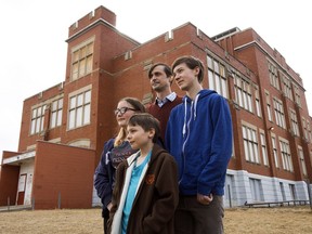 Pierre Asselin and his children Olivier, 10; Geneviève, 13; and François, 16, pose Thursday outside Ecole Joseph-Moreau, 9750  74 Ave.