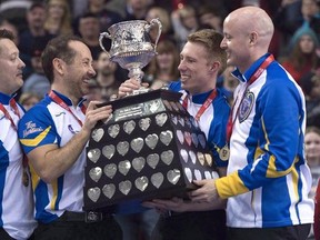 Team Alberta skip Kevin Koe, right to left, third Marc Kennedy, second Brent Laing and lead Ben Hebert hoist the Brier tankard following the gold medal game at the Brier curling championship Sunday March 13, 2016 in Ottawa. The Tim Hortons Brier begins Thursday night with the qualification round opener at Mile One Centre in St. John&#039;s. The 12-team main draw kicks off Saturday afternoon. THE CANADIAN PRESS/Adrian Wyld
