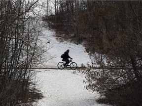 A cyclist rides on the trail near Gold Bar Park on Thursday March 23, 2017 in Edmonton.