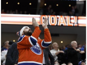 A fan applauds Edmonton's Matt Hendricks (23) goal during the second period of a NHL game at Rogers Place in Edmonton on Friday, January 20, 2017.