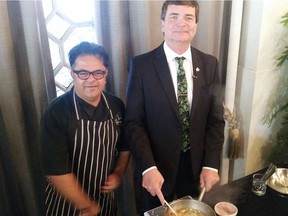 Alberta Agriculture Minister Oneil Carlier cooks with celebrity chef Vicky Ratnani during a recent trade mission to India.