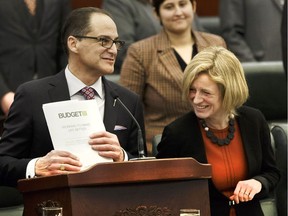 Alberta Finance Minister Joe Ceci, left, alongside Premier Rachel Notley speaks as he tables Budget 2017 in the Alberta Legislature on Thursday, March 16, 2017.