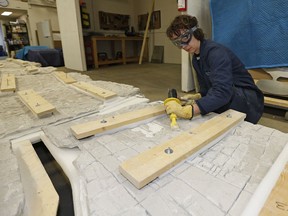 Andrea Bowes works on the restoration of a 50-year-old mural by artist Norman Yates. The mural was extracted from the former downtown Edmonton library.