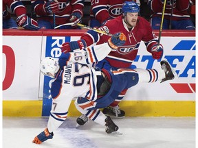 Montreal Canadiens' Andrew Shaw (65) checks Edmonton Oilers' Connor McDavid during first period NHL hockey action in Montreal, Sunday, February 5, 2017. The Oilers host the Canadiens on Sunday at Rogers Place.