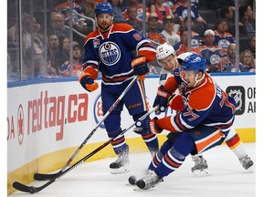 EDMONTON, AB - SEPTEMBER 26:  Adam Larsson #6 and Oscar Klefbom #77 of the Edmonton Oilers defend their zone against Garnet Hathaway #64 of the Calgary Flames in an NHL preseason game on September 26, 2016 at Rogers Place in Edmonton, Alberta, Canada.