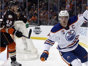 Edmonton Oilers center Connor McDavid, right, celebrates after scoring against the Anaheim Ducks, as defenseman Josh Manson, left, skates past the net during the first period of an NHL hockey game in Anaheim, Calif., Wednesday, March 22, 2017.