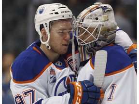 Edmonton Oilers center Connor McDavid, left, congratulates goalie Laurent Brossoit at the end of the third period of an NHL hockey game against the Colorado Avalanche late Thursday, March 23, 2017, in Denver. Edmonton won 7-4.