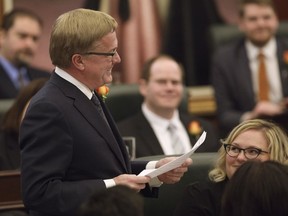Minister of Education David Egan tables Bill 1, an act to reduce school fees, after the speech from the throne, in Edmonton on Thursday, March 2, 2017.