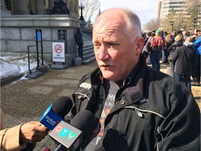 Garett Schmidt, organizer of a protest against the NDP government's plans to ban off-highway vehicles from the Castle parks area in southwestern Alberta, speaks to reporters outside the legislature Saturday.