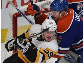 Edmonton Oilers defenceman Adam Larsson and Pittsburgh Penguins' Jake Guentzel jockey for position in front of the net at Rogers Place in Edmonton on Saturday, March 10, 2017. (Ed Kaiser)